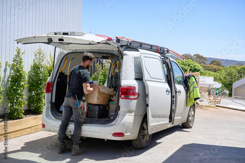 Electrician loading work van
