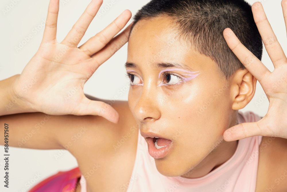 Portrait of young mixed race woman on white/grey background