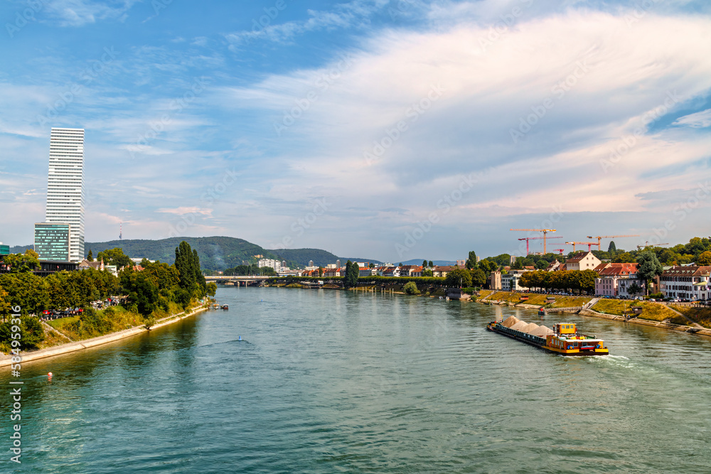 Self propelled barge carrying construction material in River Rhine, Basel, Switzerland