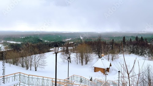 View of the chapel near the Belogorsky St. Nicholas Orthodox Missionary Monastery. Winter forest. The temple on the hill in winter. Russia, Perm Krai, Belaya Gora. 4K photo