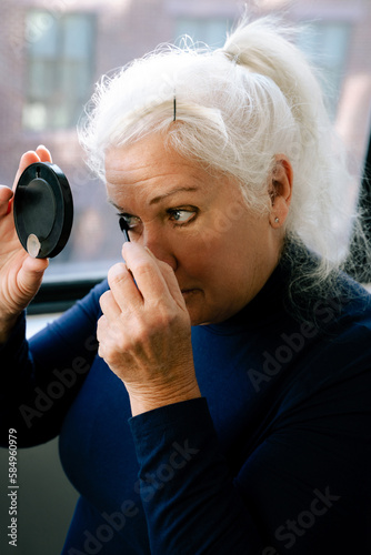 Senior Woman Applying Makeup photo