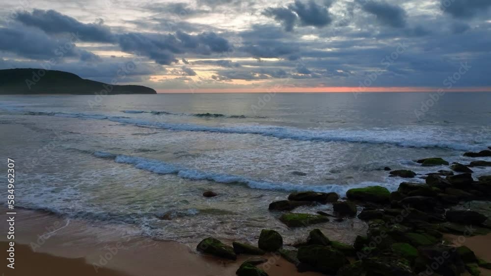 Sunrise seascape with colour and clouds at Killcare Beach on the Central Coast, NSW, Australia. Sunrise seascape with colour and clouds at Killcare Beach on the Central Coast, NSW, Australia.