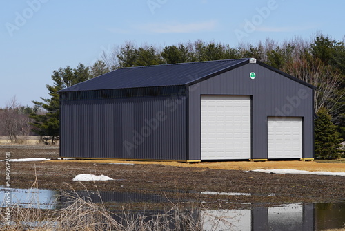 Large metal black storage unit sits on roadside holding owner belongings.