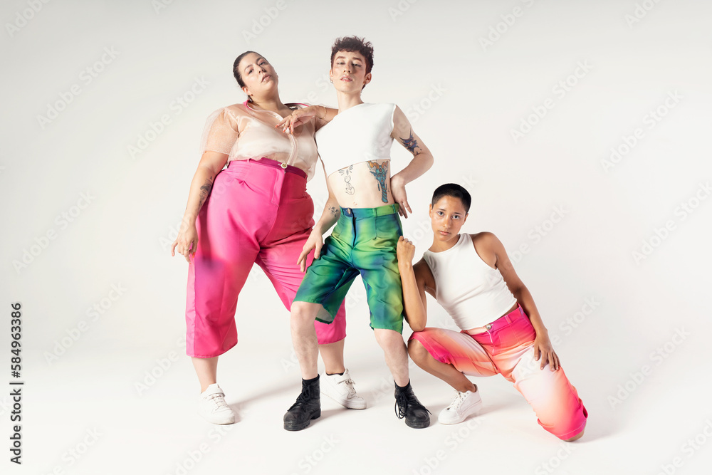 Portrait of joyful young friends standing in a studio Portrait of joyful young friends standing in a studio