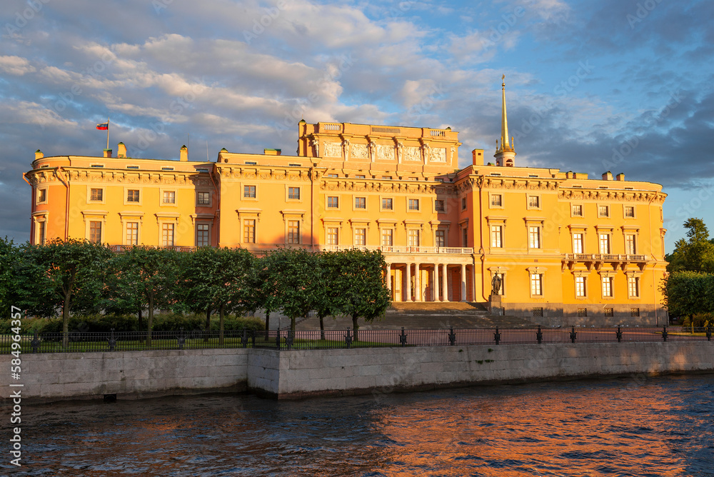 Ancient Mikhailovsky (Engineering) castle in the orange light of the setting sun on a June evening. Saint-Petersburg, Russia