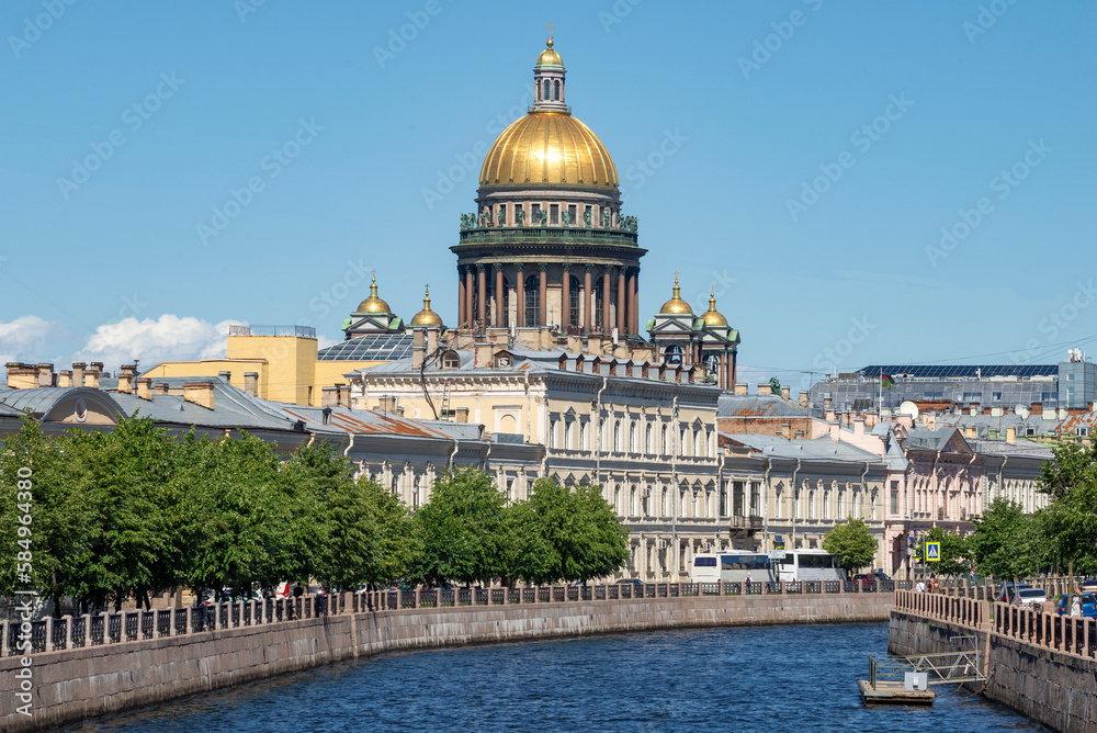 The dome of St. Isaac's Cathedral over the Moika river on a sunny June day. Saint-Petersburg, Russia
