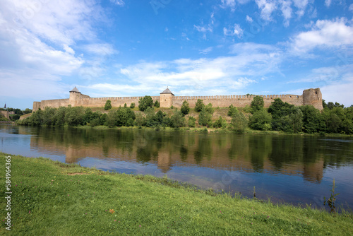 View of the Russian ancient Ivangorod fortress from the Estonian bank of the Narova river on a sunny August day. Border of Estonia and Russia