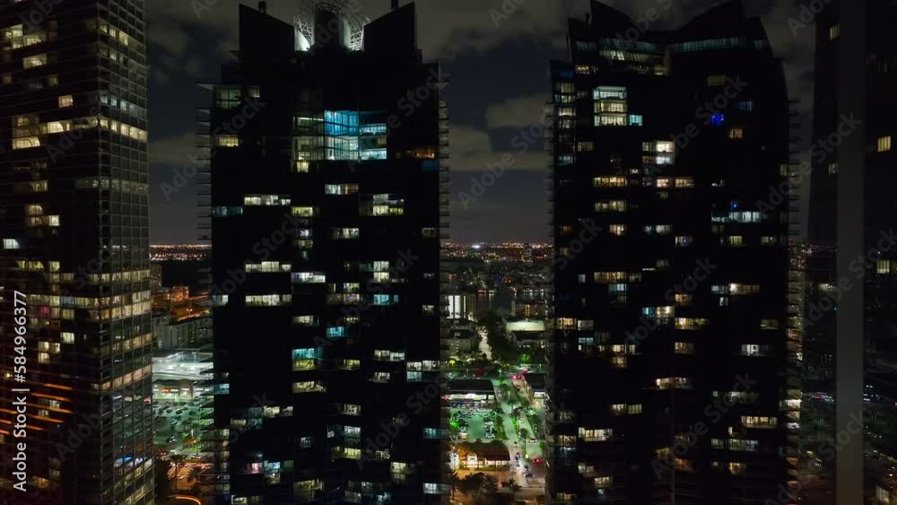 Aerial view of downtown district in Sunny Isles Beach city in Florida, USA. Brightly illuminated high skyscraper buildings in modern american midtown Aerial view of downtown district in Sunny Isles Beach city in Florida, USA. Brightly illuminated high skyscraper buildings in modern american midtown