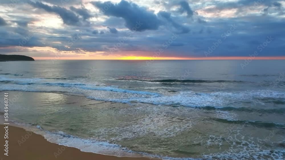 Sunrise seascape with colour and clouds at Killcare Beach on the Central Coast, NSW, Australia. Sunrise seascape with colour and clouds at Killcare Beach on the Central Coast, NSW, Australia.