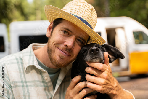 man with dog and camper van