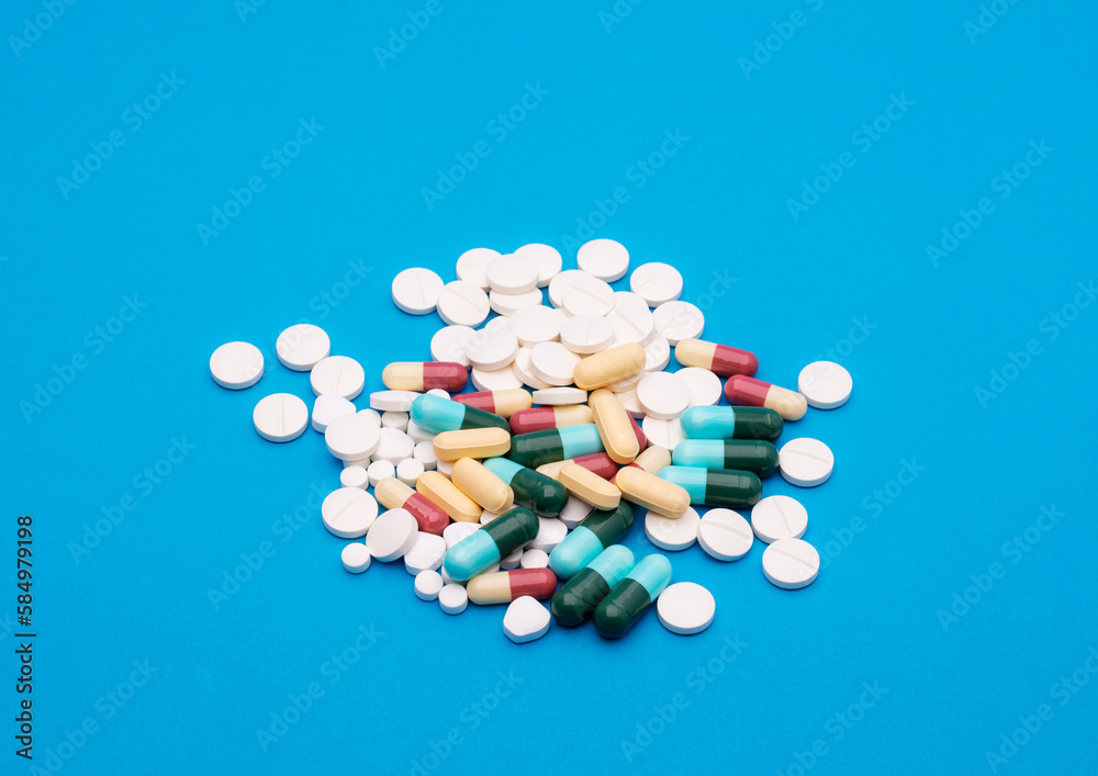 green capsule pill on blue background table medicine vitamin antibiotic and medical treatment of hospital and clinic