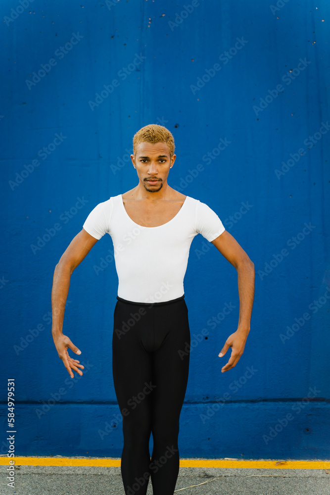 Energetic Dancer Dancing In Front Of A Blue Wall Energetic Dancer Dancing In Front Of A Blue Wall