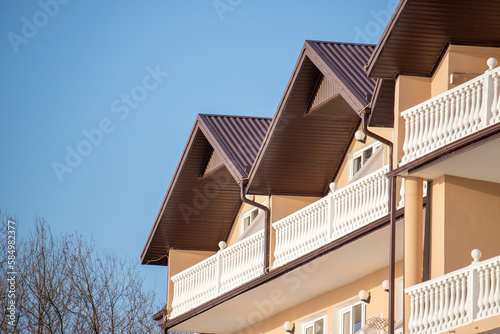 Roofs of houses with dormer windows against the sky. Urban architecture.