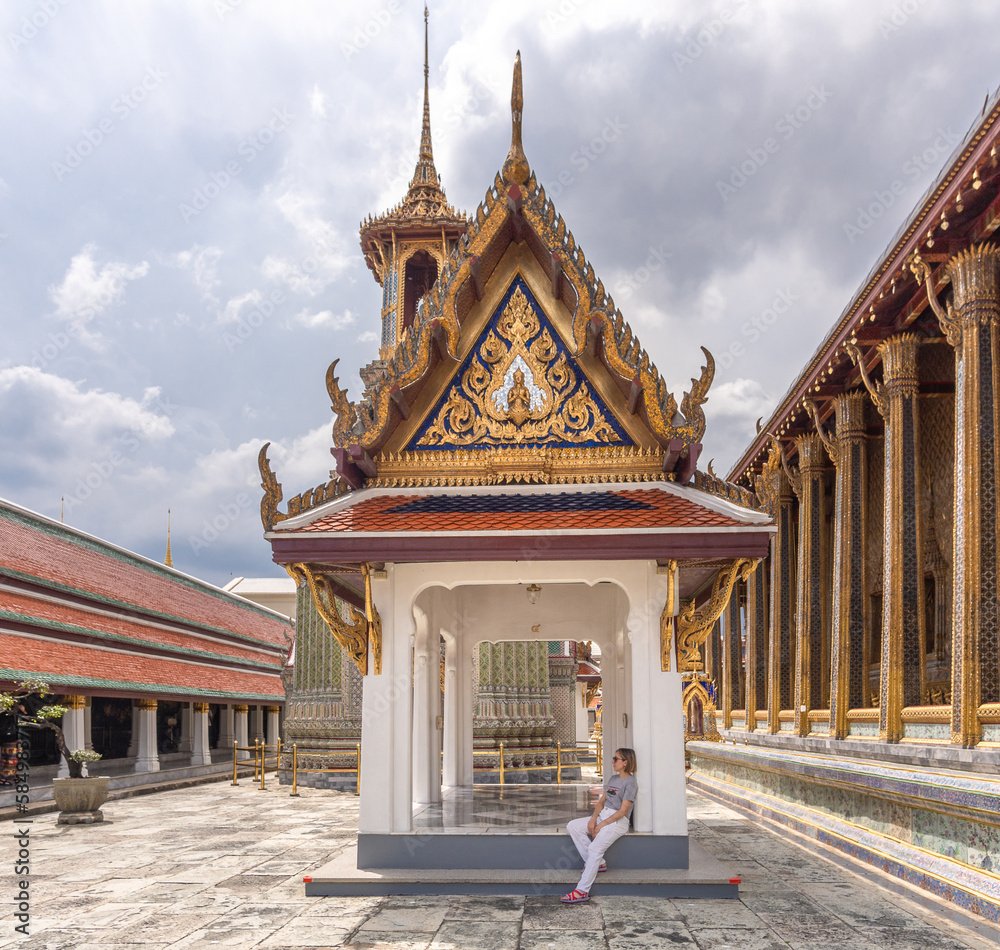 woman resting from the sun in the Grand palace of bangkok thailand
