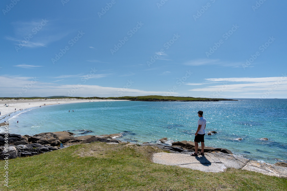Traveler man admiring breathtaking scenery on Dogs bay beach