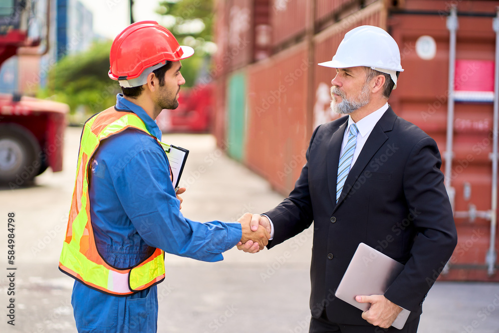 Foreman shake hand with Inspector manager in container site for start the work to audit service Foreman shake hand with Inspector manager in container site for start the work to audit service