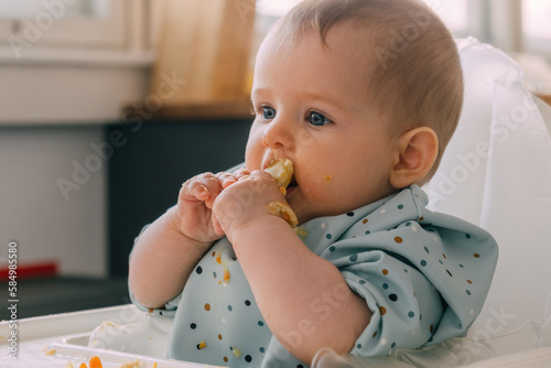 infant eating with hands 
