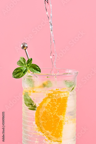 Mint and orange cocktail pouring
