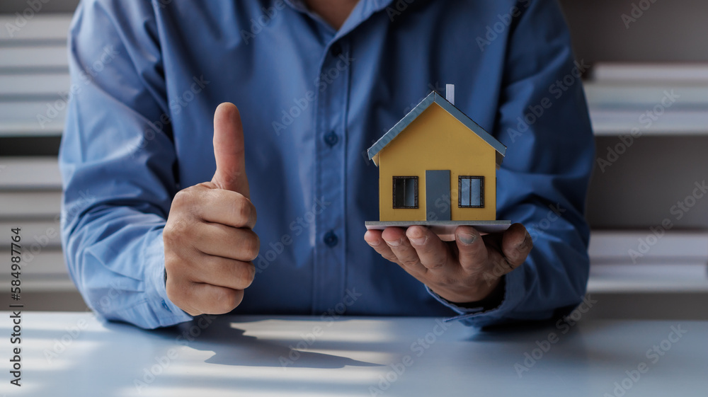 real estate agent Hand over the keys and the model house to the customer and the home insurance contract. home mortgage loan concept