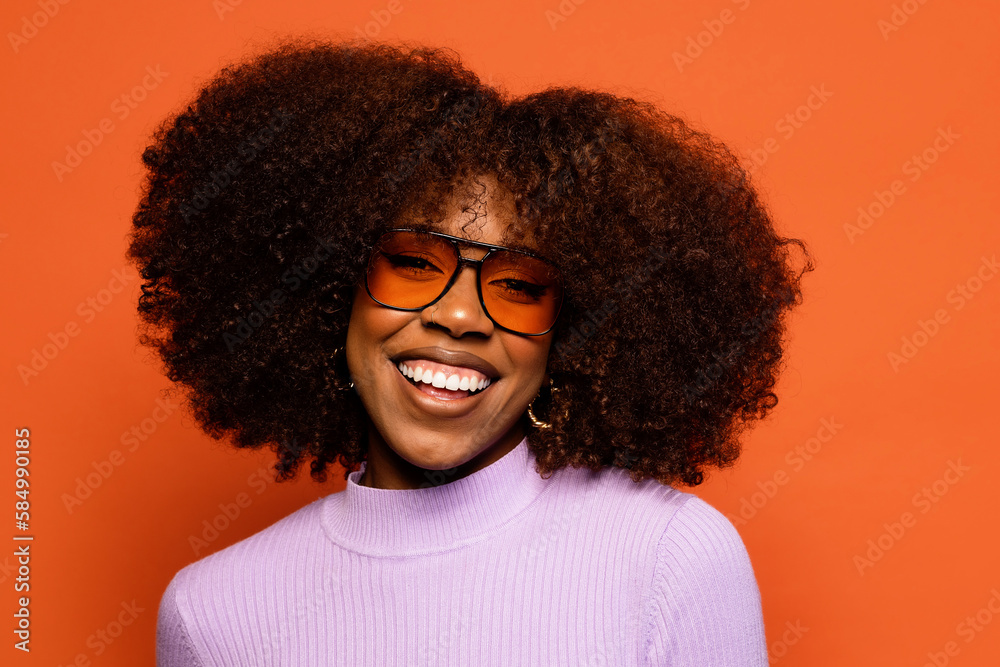 Cheerful black woman with curly hair and sunglasses Cheerful black woman with curly hair and sunglasses