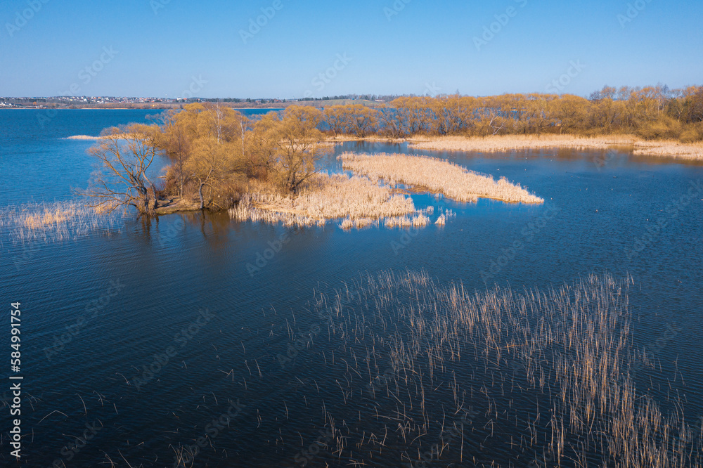 An aerial panoramic view on a lake in early spring time