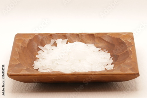 Magnesium chloride detailed closeup on wooden bowl. natural mineral