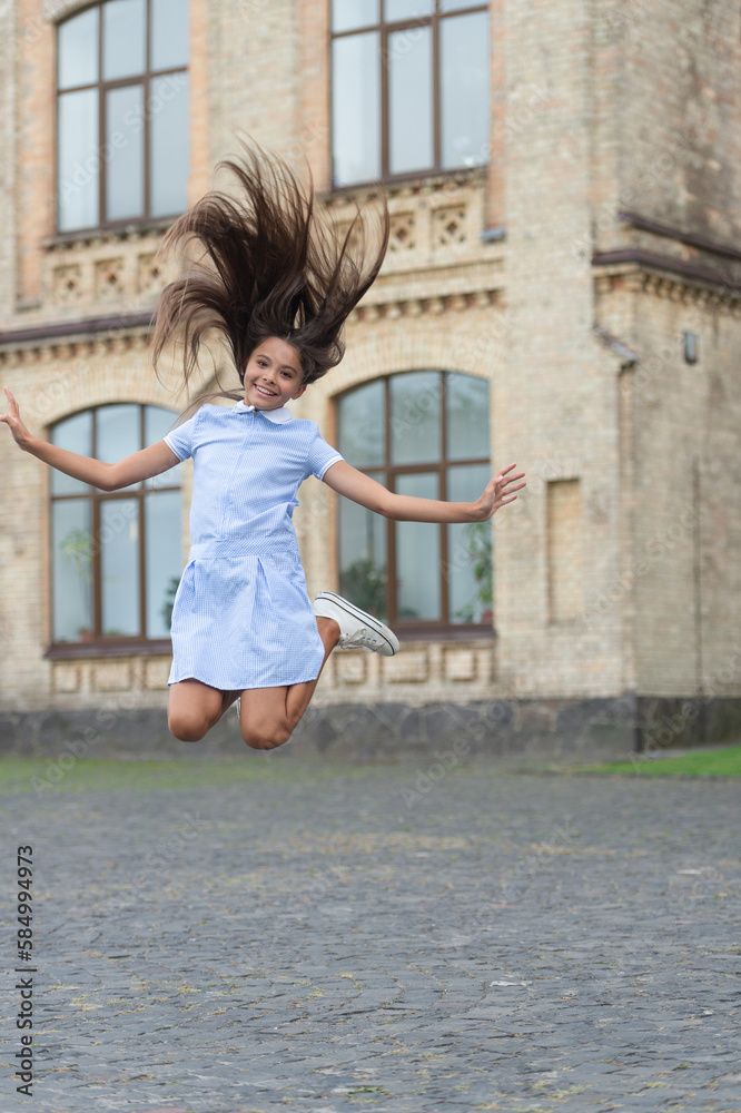 childhood happiness of glad teen girl outdoor. childhood happiness of teen girl jumping outside