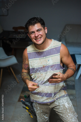 Transgender man doing a handyman job photo