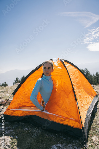 Girl in the orange tent sitting