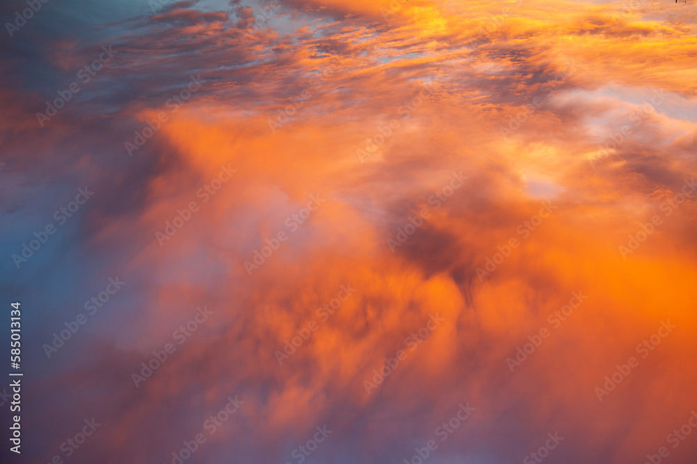 dramatic orange clouds in the blue sky at sunset dramatic orange clouds in the blue sky at sunset