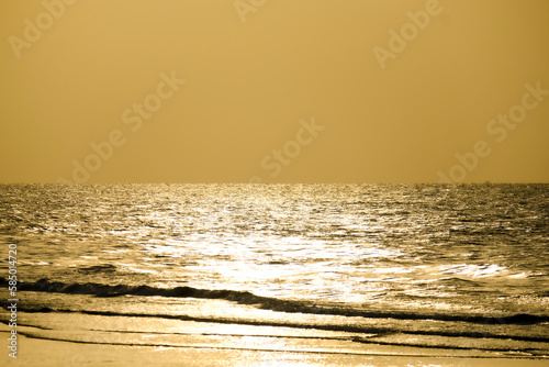 sunlight at sunset reflected on the sea surface turned into a beautiful golden color.