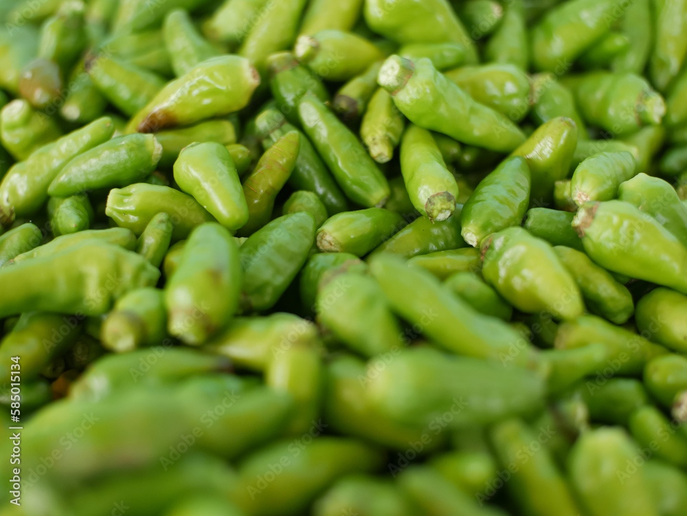 pile of green cayenne pepper pile of green cayenne pepper