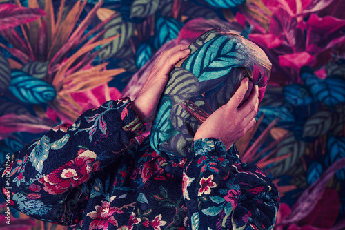 man with his head wrapped with a floral-patterned paper