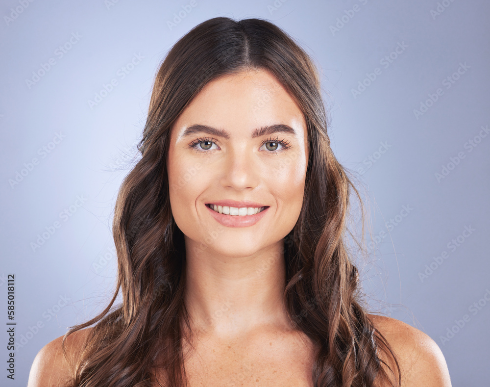 Obraz premium Woman, beauty and hair care portrait or smile in studio for texture, growth and shine on blue background. Aesthetic female happy for haircare, skincare and natural cosmetics for salon or hairdresser