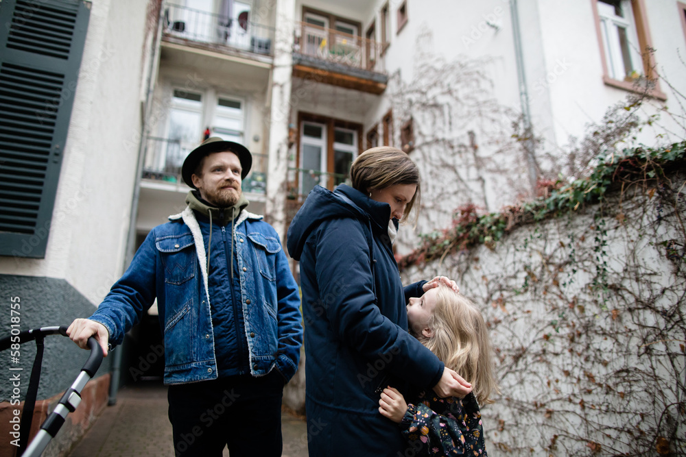 Parents and little daughter in alley Parents and little daughter in alley