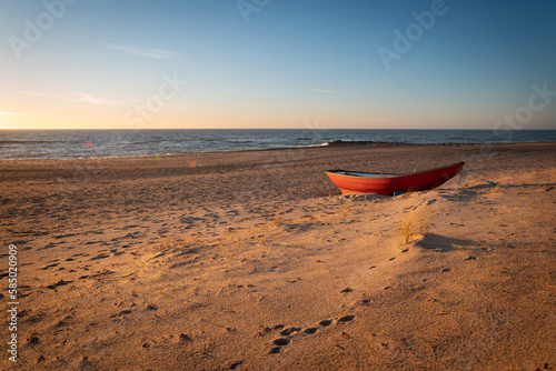 boat at sunset on a sandy beach in denmark © Carolin