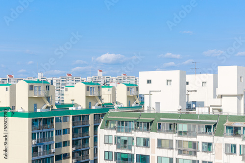 Tall apartment buildings and sunny sky. photo