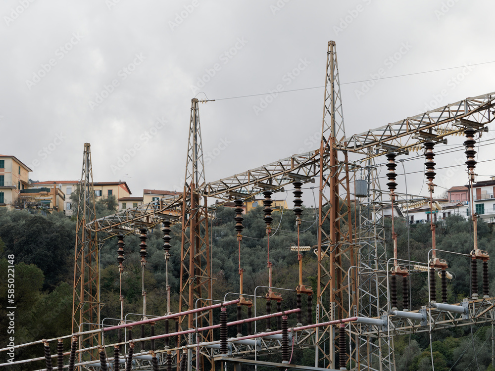 Electricity distribution station. Lots of wires, poles and shields. Spring, on the background of dark clouds. Electricity distribution station. Lots of wires, poles and shields. Spring, on the background of dark clouds.
