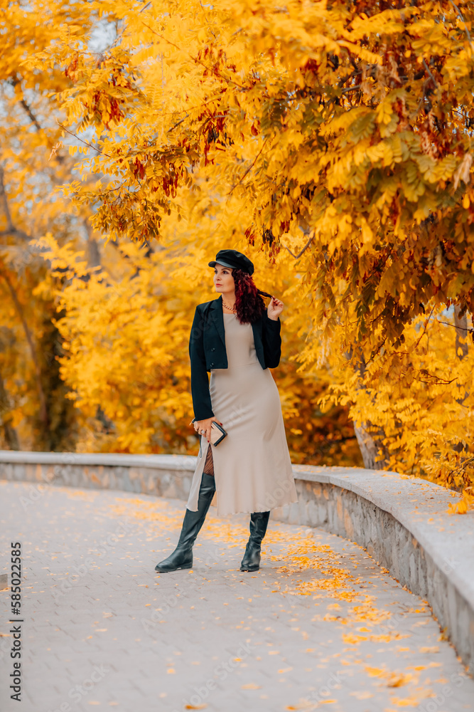 A woman walks outdoors in autumn, enjoys the autumn weather. A woman walks outdoors in autumn, enjoys the autumn weather.