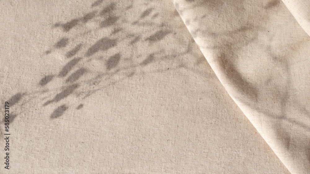 Aesthetic natural minimalistic background, elegant sunlight floral shadows on neutral beige linen texture pleated tablecloth, background with copy space - obrazy, fototapety, plakaty 