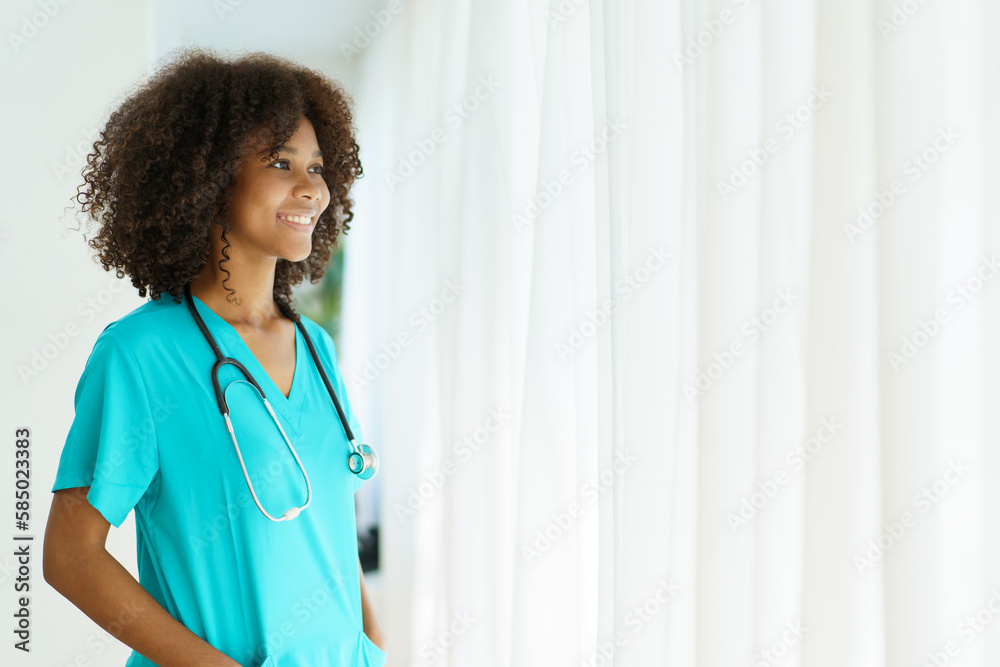 Beautiful American - African black ethnicity female doctor standing in the hospital portrait with copyspace. Surgery female doctor portrait at hospital. Beautiful American - African black ethnicity female doctor standing in the hospital portrait with copyspace. Surgery female doctor portrait at hospital.