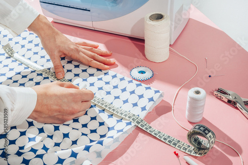 seamstress chalking measurements on material