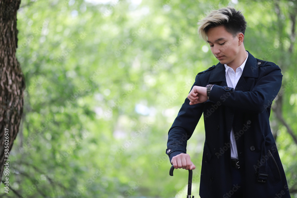 Spring rainy weather and a young man with an umbrella Spring rainy weather and a young man with an umbrella
