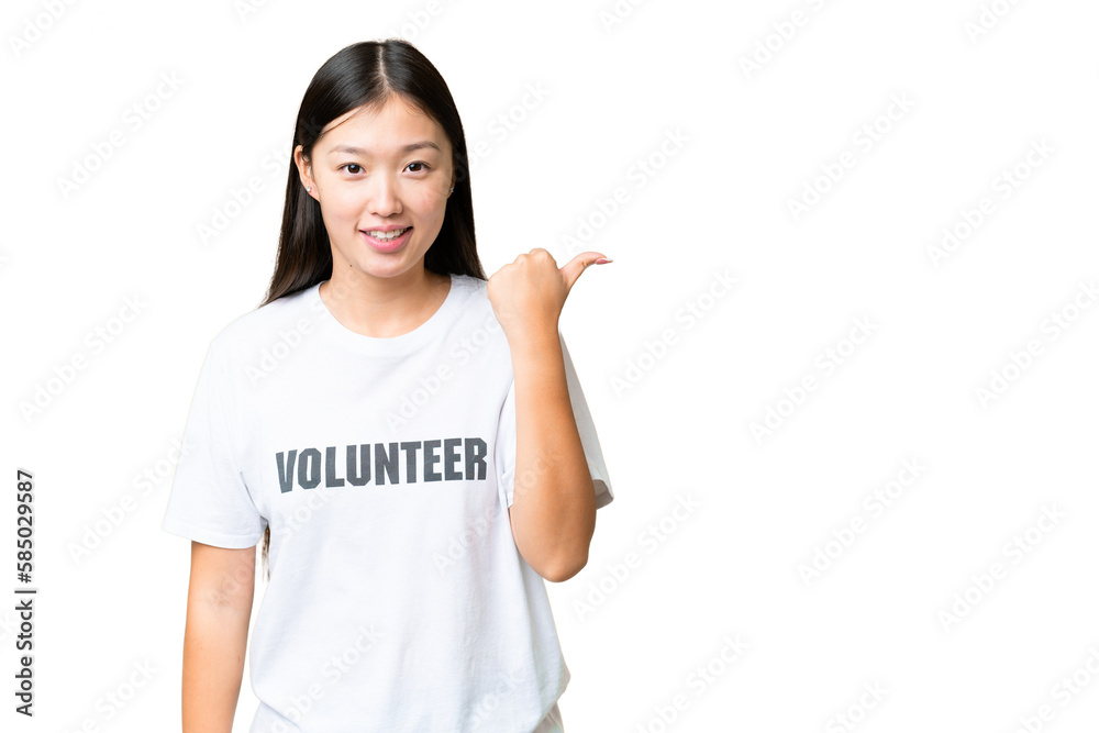 Young volunteer woman over isolated chroma key background pointing to the side to present a product Young volunteer woman over isolated chroma key background pointing to the side to present a product