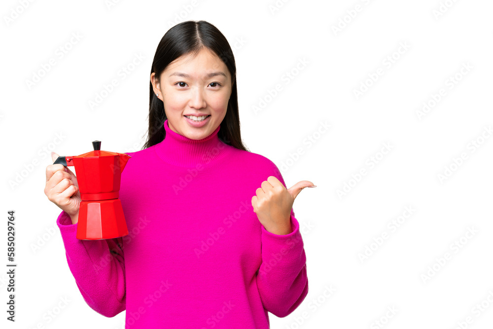 Young Asian woman holding coffee pot over isolated chroma key background pointing to the side to present a product Young Asian woman holding coffee pot over isolated chroma key background pointing to the side to present a product