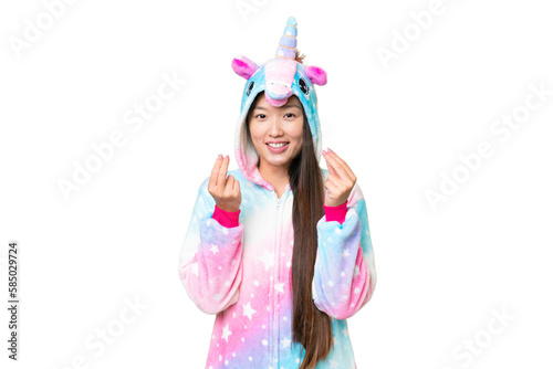 Young Asian woman with unicorn pajamas over isolated chroma key background making money gesture