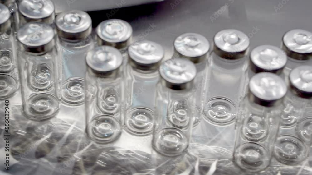 Movement of the conveyor line with transparent ampoules. Movement of the conveyor line with transparent ampoules.