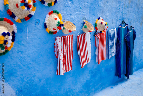 Hats and carpets on a blue wall photo