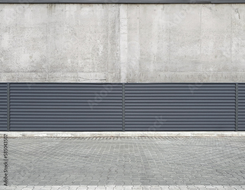 Urban metal corrugated fence against a concrete building or wall along the road. Gray modern decorative or technical fence. urban environment