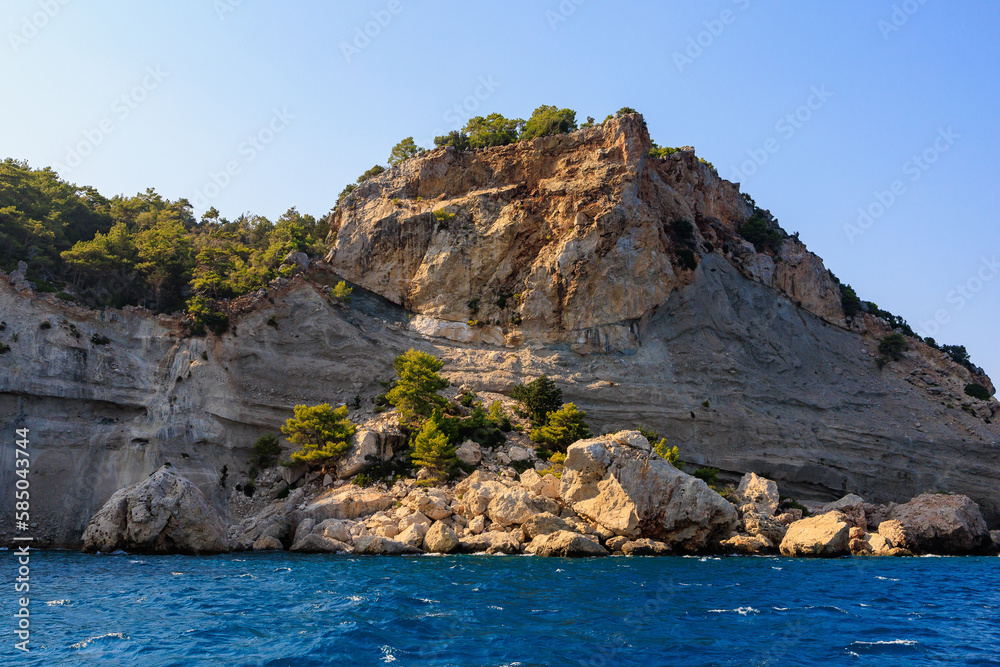 View of the rocky shore from the sea. Mediterranean Sea in Turkey. Popular tourist places. Background View of the rocky shore from the sea. Mediterranean Sea in Turkey. Popular tourist places. Background